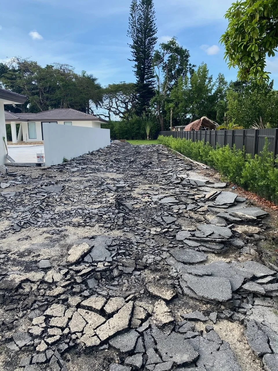 Old asphalt driveway broken out ahead of a paver installation, Miami, FL