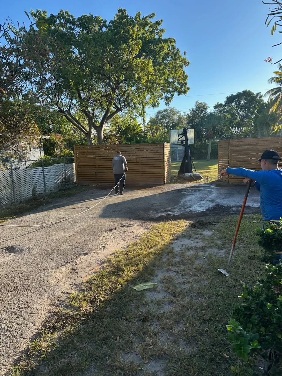 Old driveway surface hosed down and prepped before new asphalt, Miami, FL