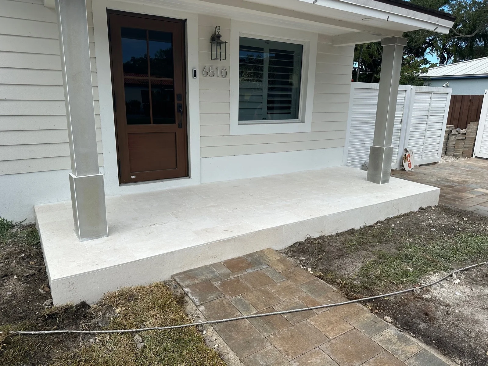 Poured concrete front porch with a clean edge along the planting bed, Miami, FL