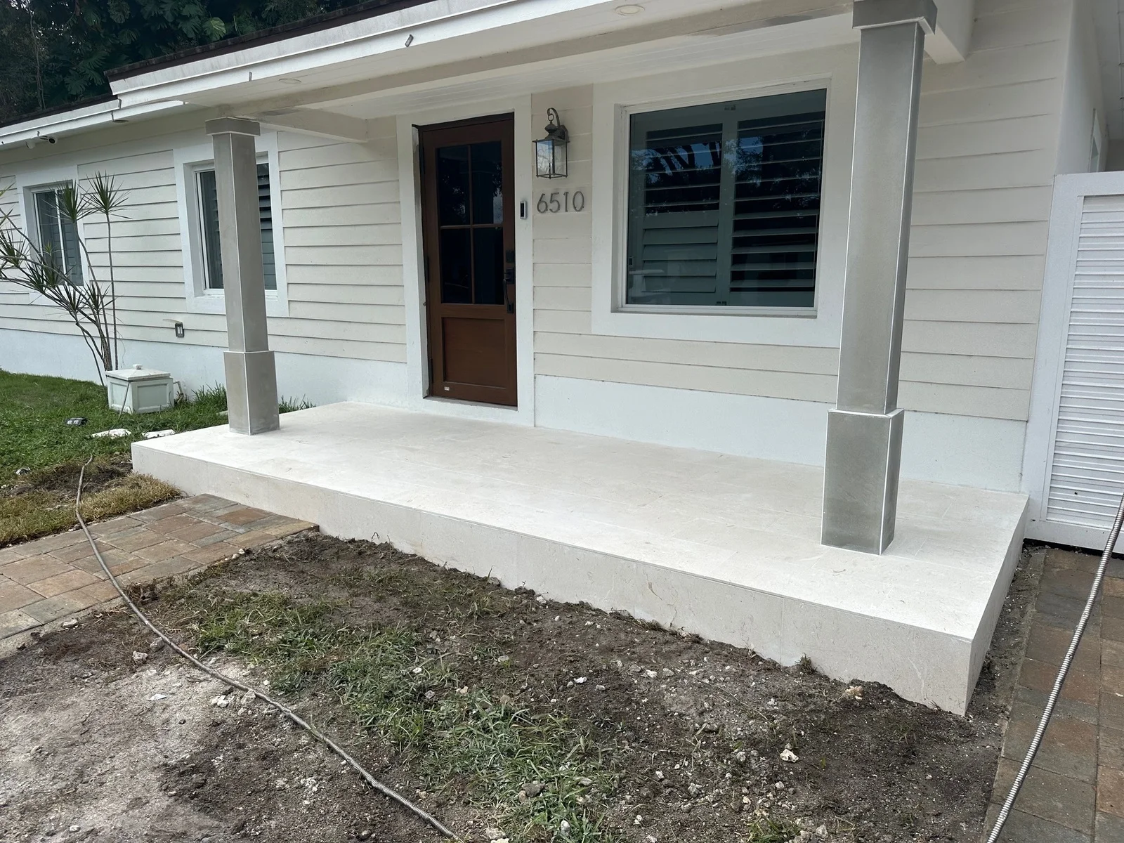 New poured concrete front porch and step at a single-story house, Miami, FL