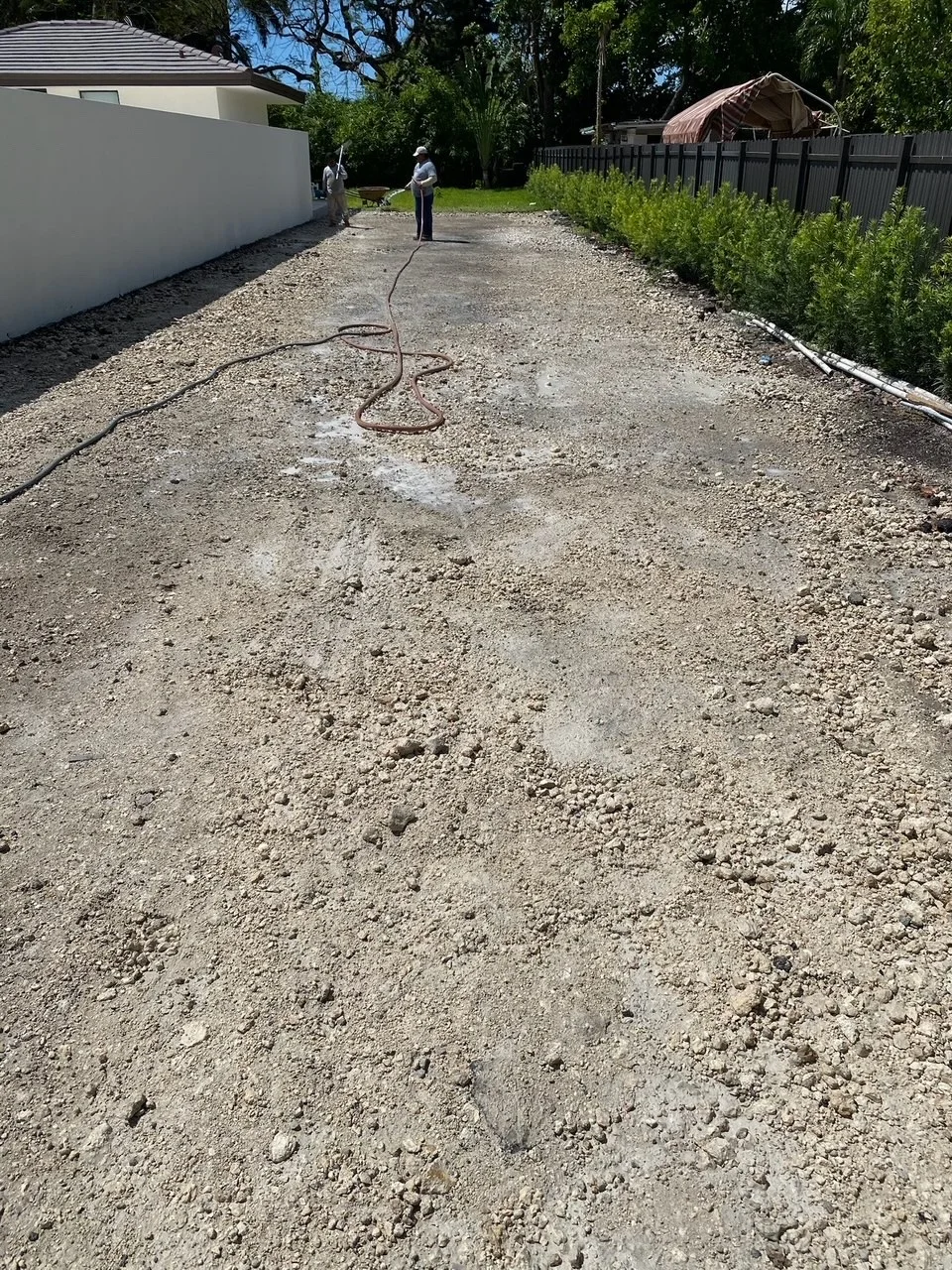 Compacted limerock base graded in front of a house before pavers go down, Miami, FL