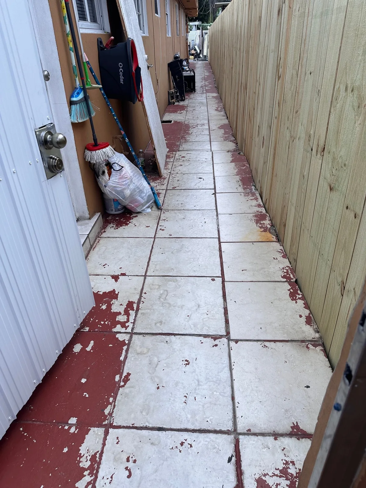 Old painted tile walkway along a fence before it was replaced with pavers, Miami, FL