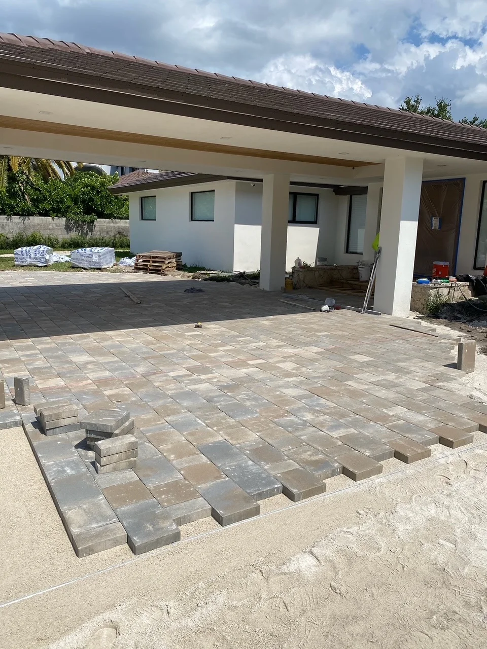 Pavers being laid under a covered entry drive, Miami, FL