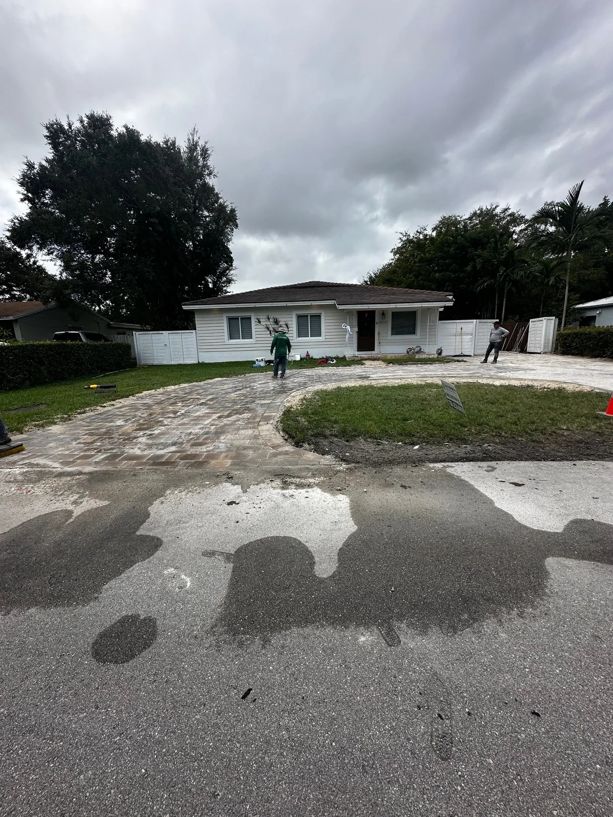 Old surface stripped back while the first paver ring of a circular drive goes down, Miami, FL